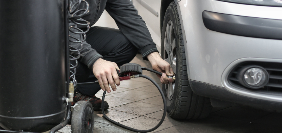 A person inflating his tire