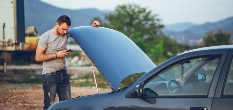Man calling help because his car is broken down