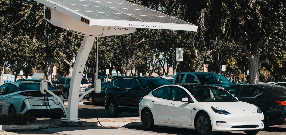 White Tesla car getting charged up at a station
