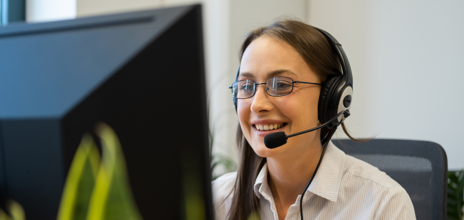 Customer service representative in front of the computer helping a client
