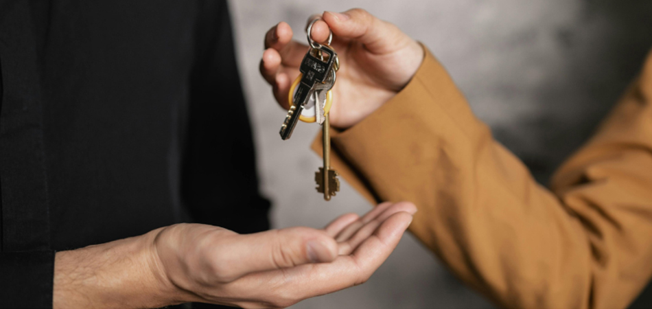 A person giving another person a car key